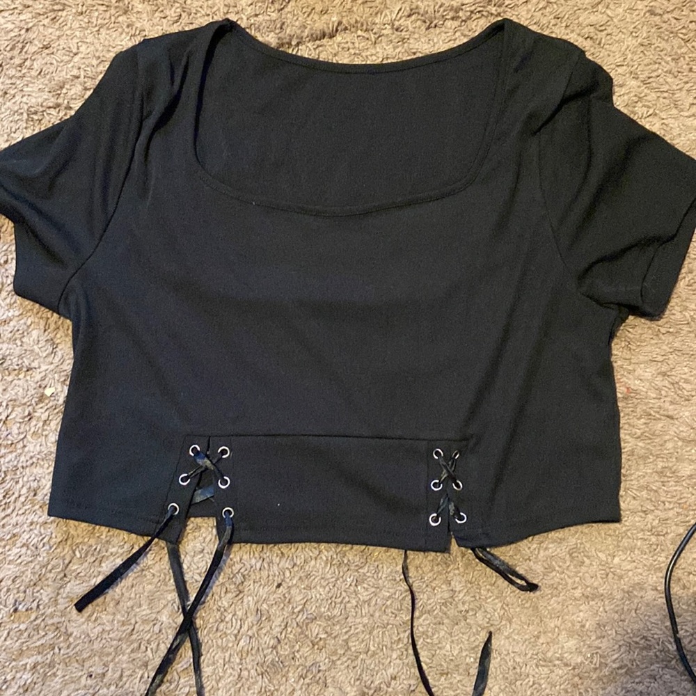 It’s a plus solid lace sweetheart neck tee. Color is black